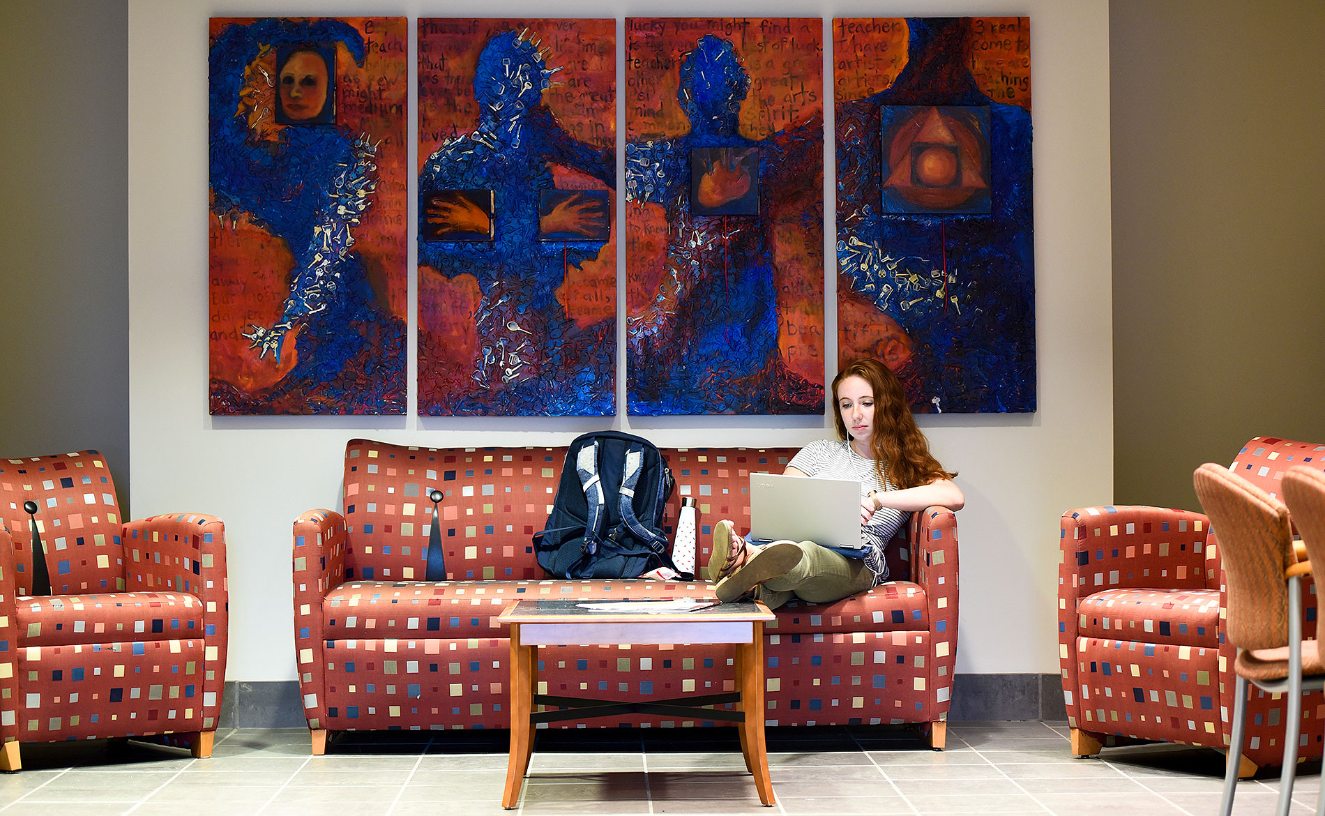 student sitting in a study area working on a computer