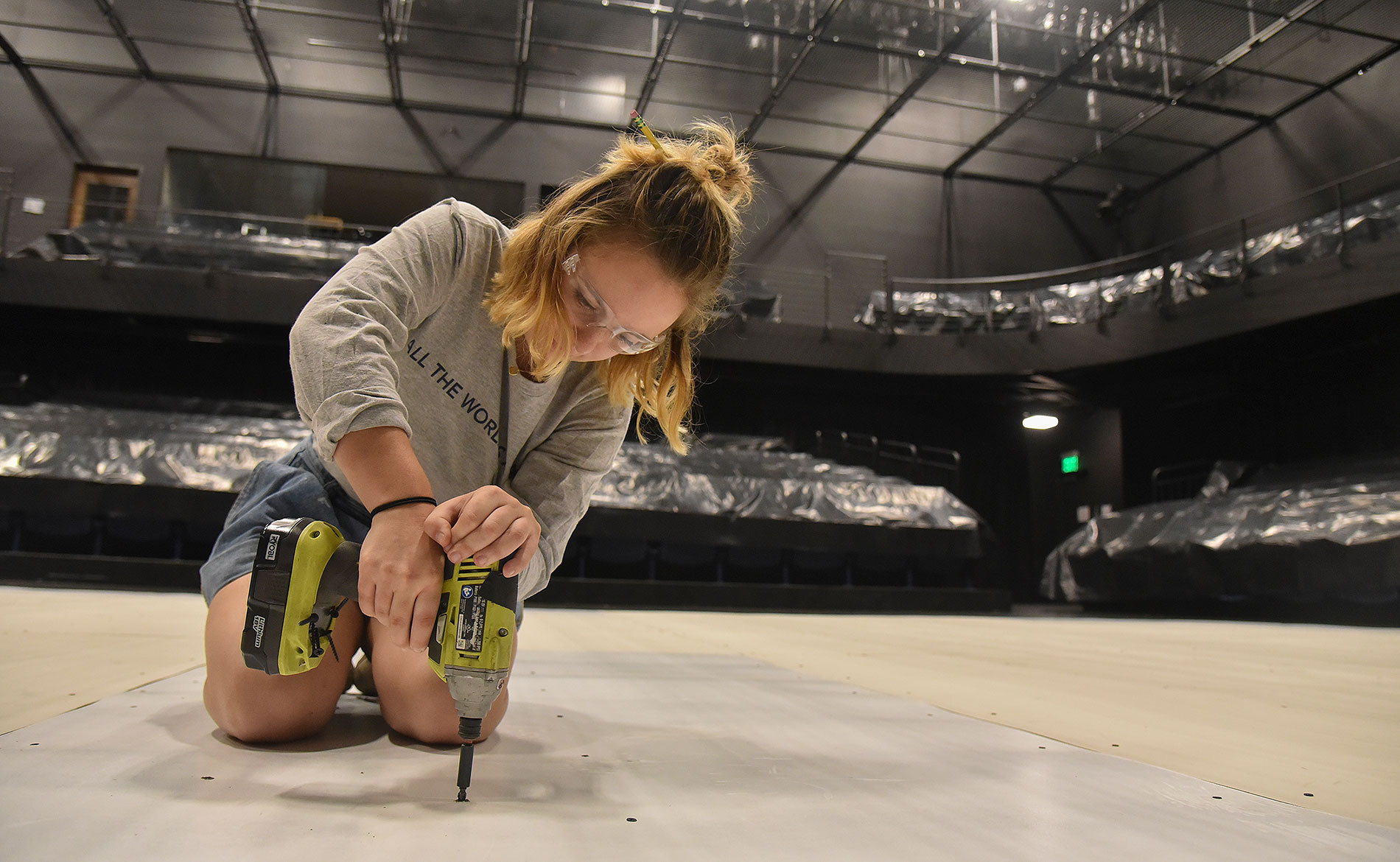 female student using a drill