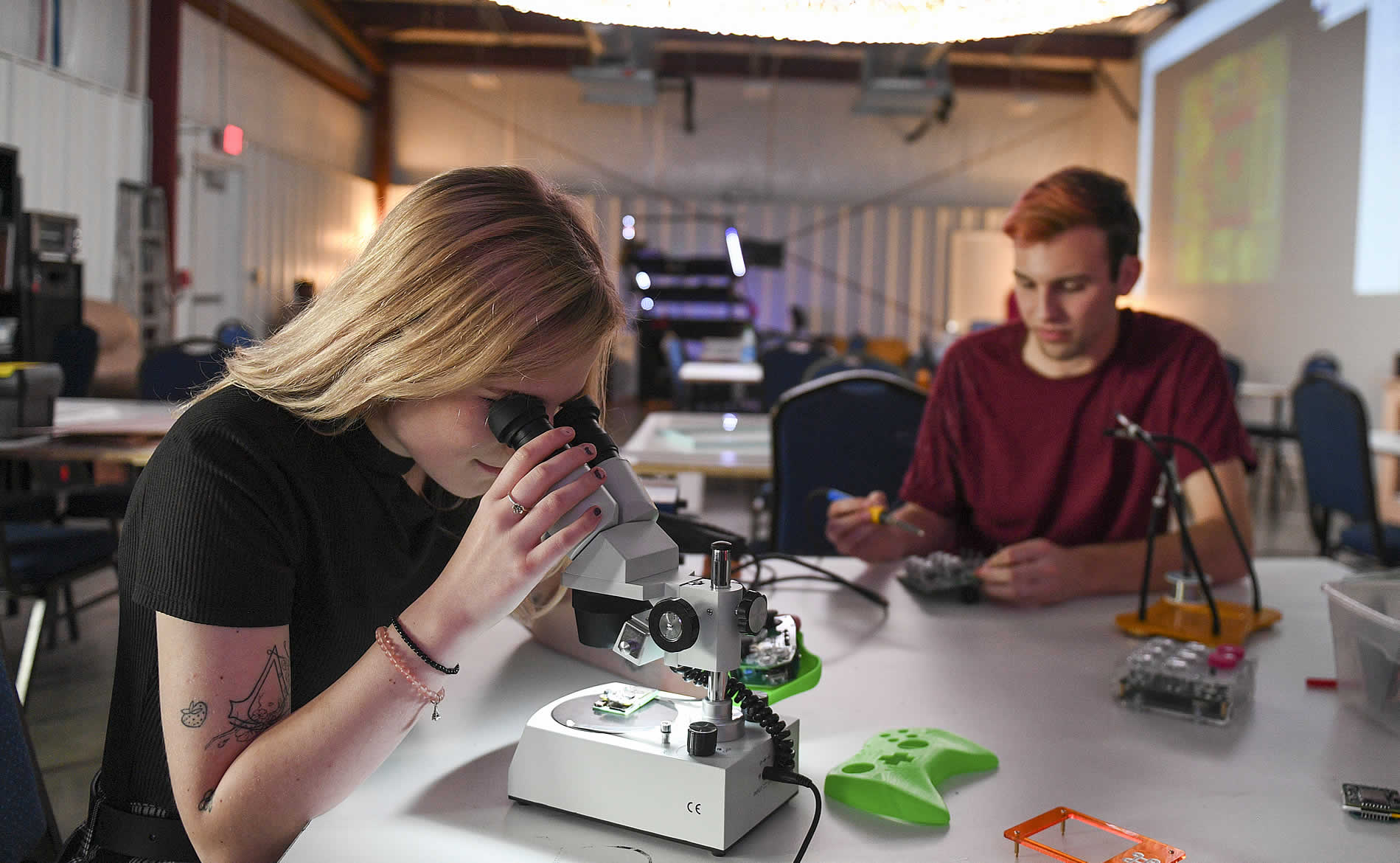 Students in a lab, looking in a microscope