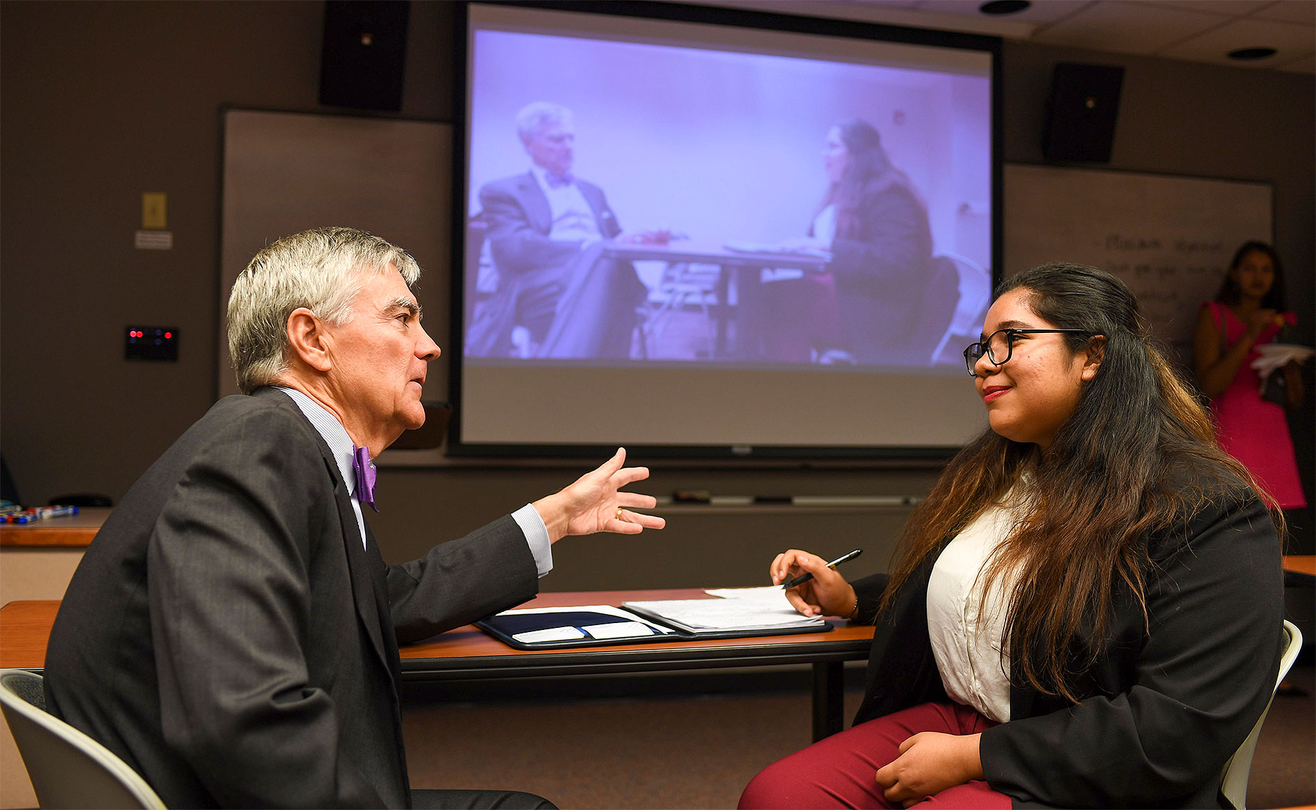 A student in conference with a mentor