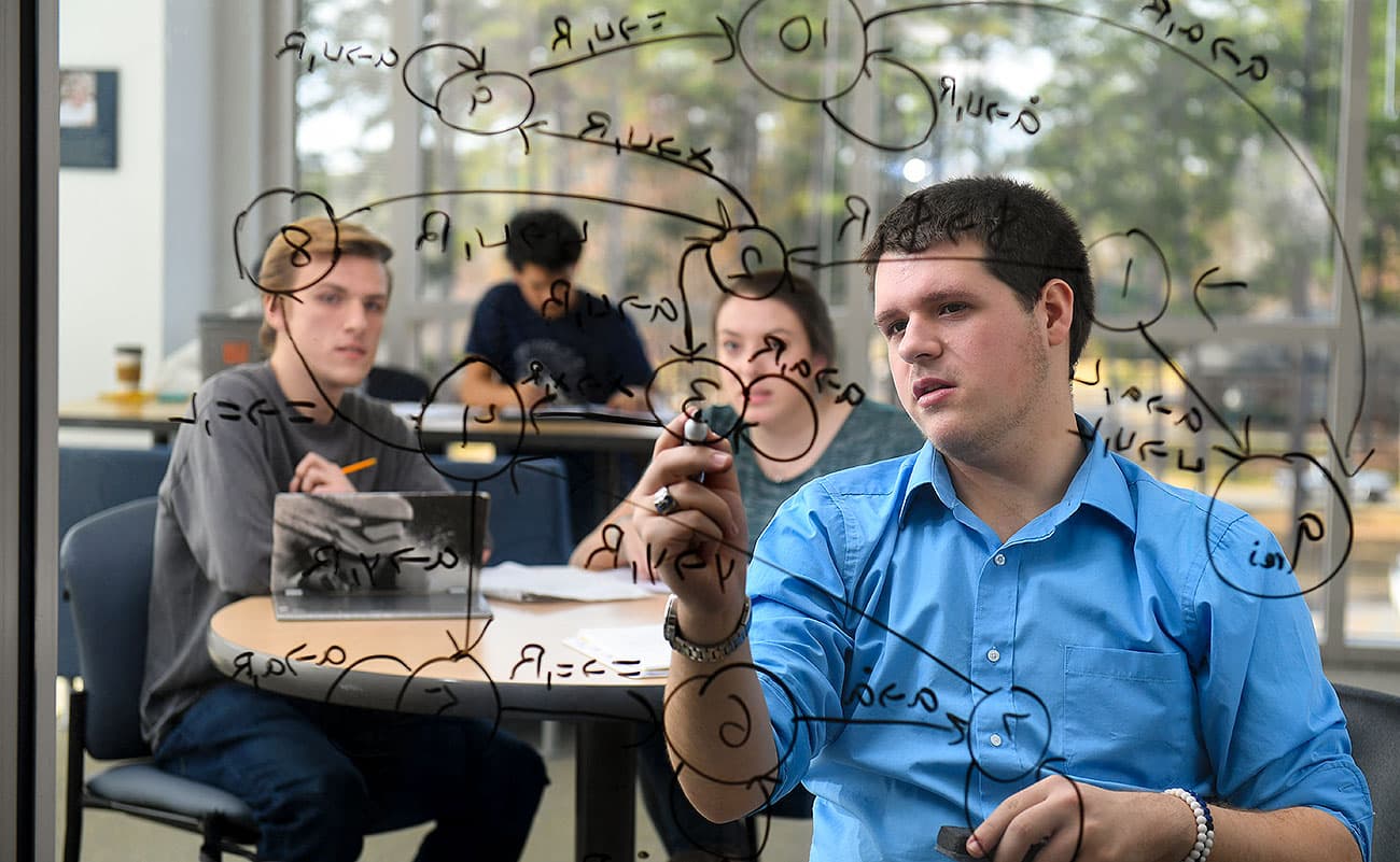 Three Students at a laptop