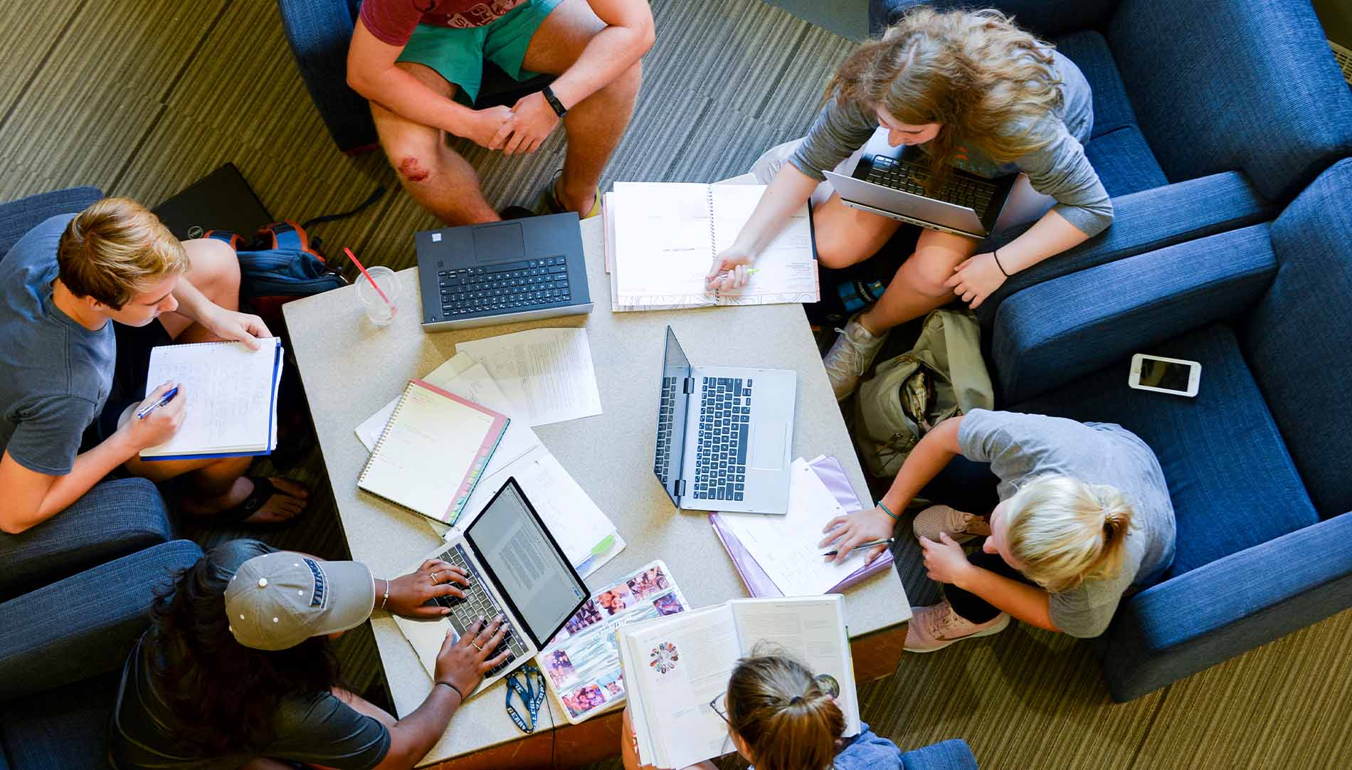 group of students studying with computers and notebooks