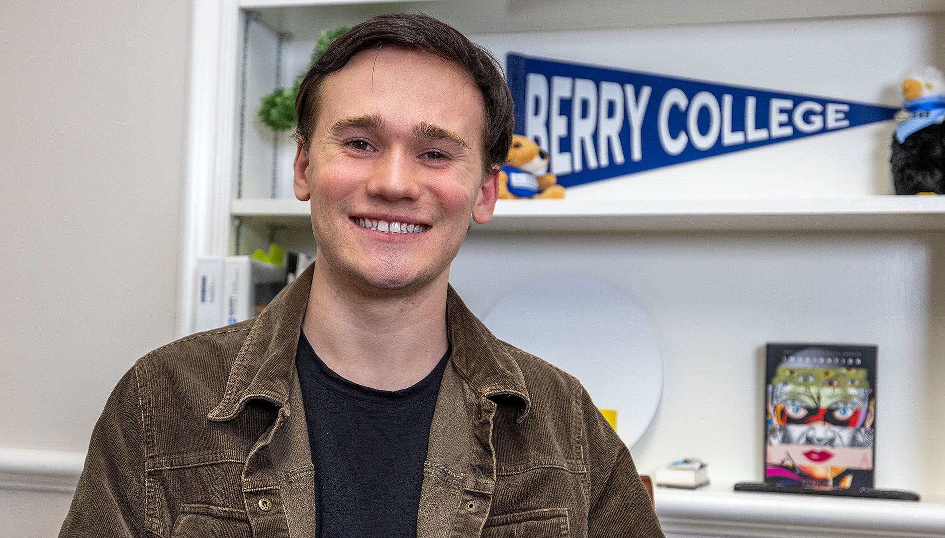 Zach Pishock in Berry College flag in background