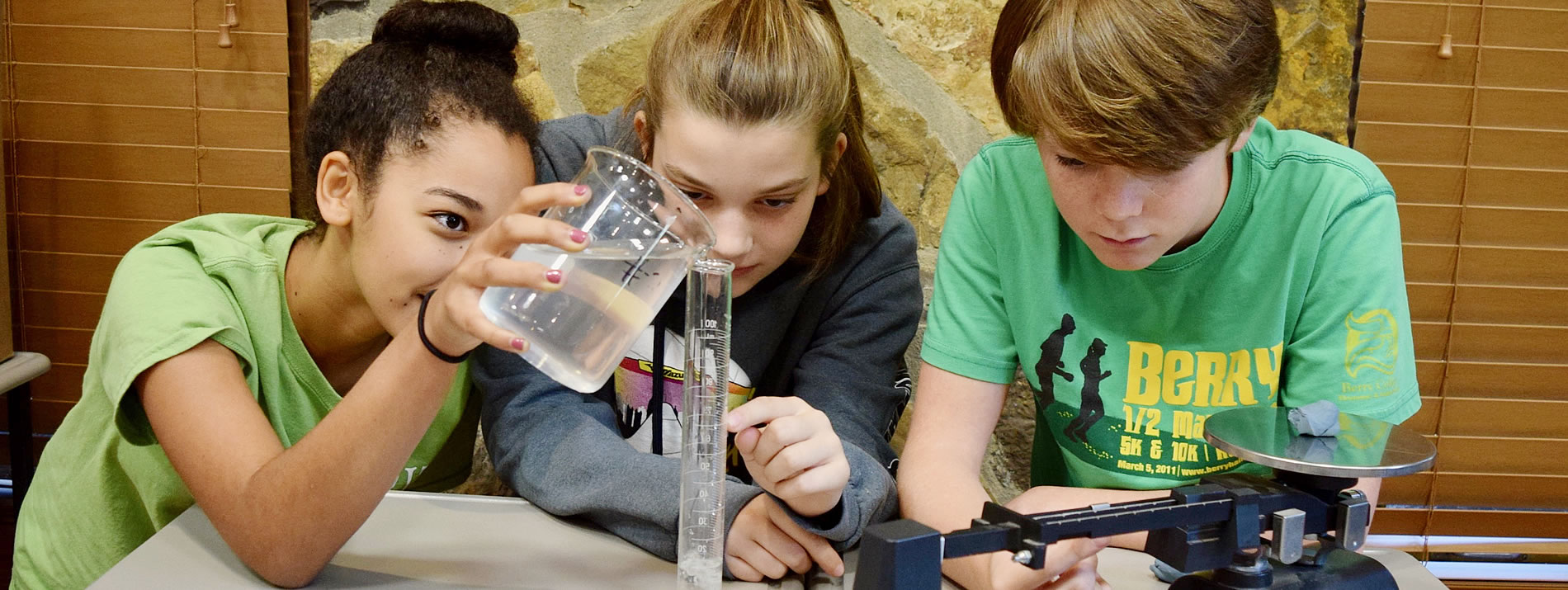 three students conducting a chemistry experiment