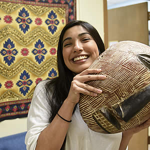 Alex Sanchez, student, holding tribal mask